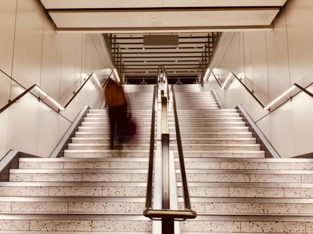 istock Defocused people rushing down the stairs 1452665262
