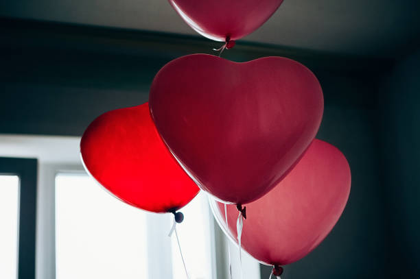 istock Heart shaped balloons against window 1452665267