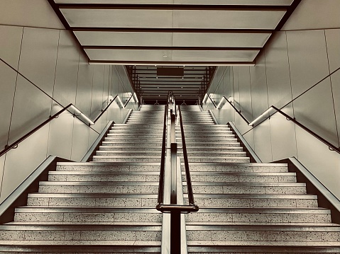Geometrical shaped stairs in an airport . Captured in the arrival area at Gatwick airport. Captured during the train strike on Boxing Day 2022