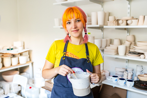 Portrait of a young girl who owns a ceramic studio