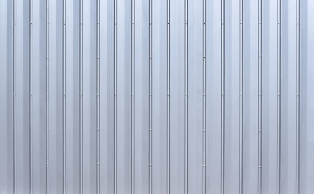 istock Silver colored aluminum wall paneling with vertical grooves and hex bolts 1452666490
