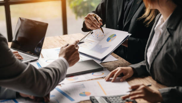 istock Businessman and team analyzing financial statement Finance task. with smart phone and laptop and  tablet. Wealth management concept 1452666698