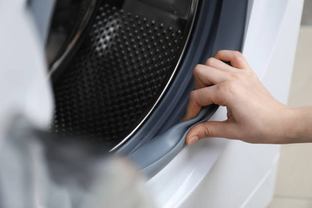istock Woman cleaning empty washing machine, closeup view 1452668185