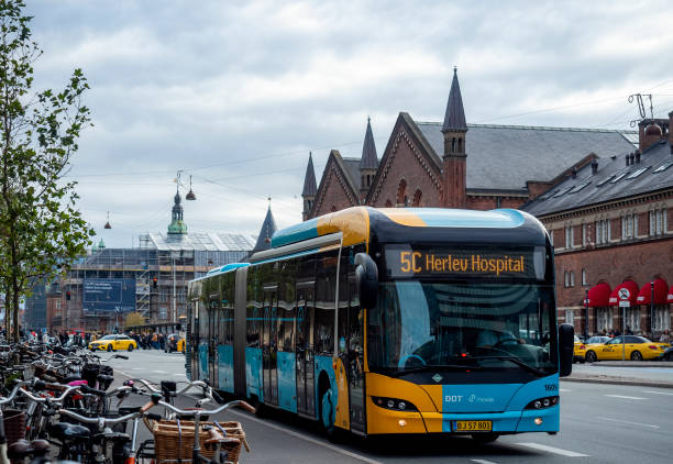 Public bus commutes outside Copenhagen Central Station on Bernstorffsgade stock photo