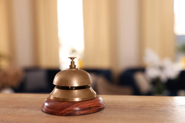 istock Hotel service bell on wooden reception desk. Space for text 1452668387