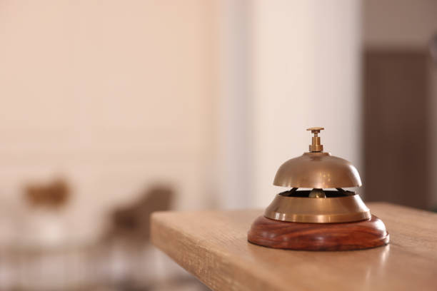 istock Hotel service bell on wooden reception desk. Space for text 1452668421