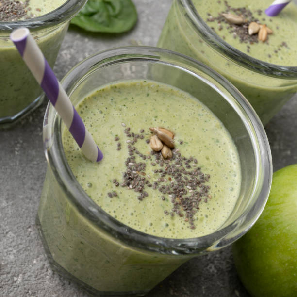 istock Healthy green spinach smoothie in glass jars 1452669303