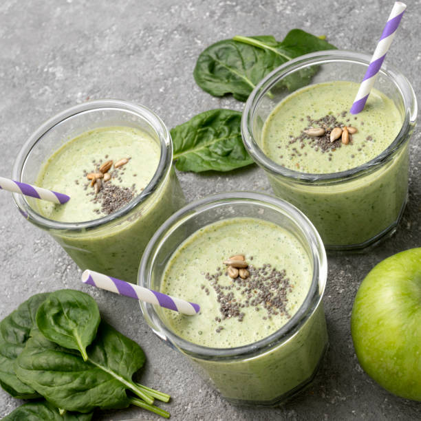 istock Healthy green spinach smoothie in glass jars 1452669304