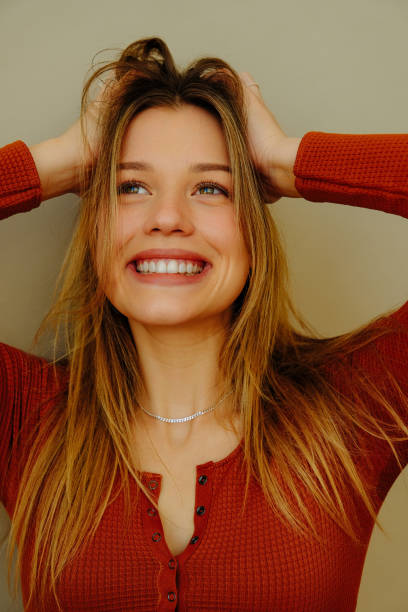 istock Young woman with hands in hair in studio 1452669387