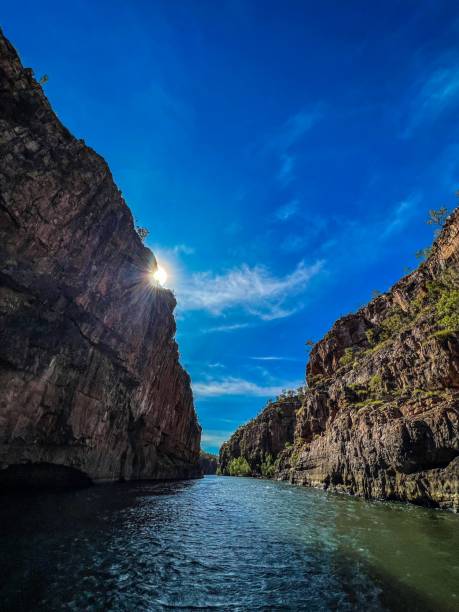 istock Vertical shot of a river surrounded by cliffs under the sunlight and a blue sky 1452669729