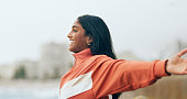 istock Happy indian woman, outdoor freedom and arms out, ocean wind and breathe fresh air with purpose or happiness, motivation and wellness, peace and hope. Smile, optimism and dream, success in nature 1452669734