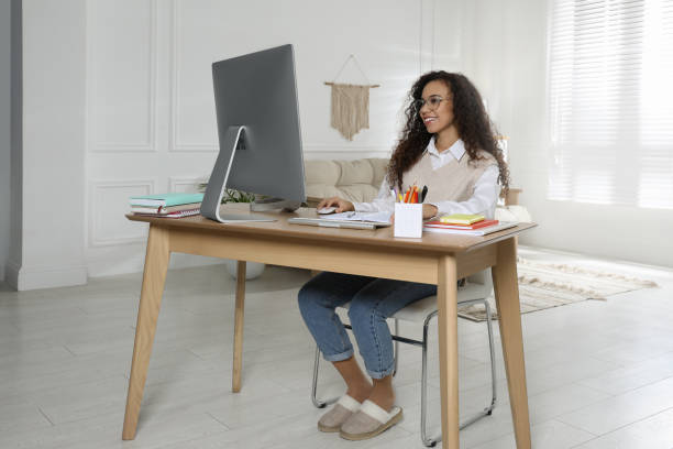 istock African American woman using modern computer for studying at home. Distance learning 1452671127