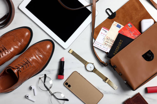 istock Flat lay composition with documents, money and accessories on white marble background. Packing for business trip 1452676479