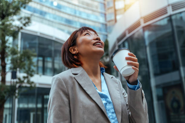 istock Young business woman having a break drinking an hot coffee 1452677679