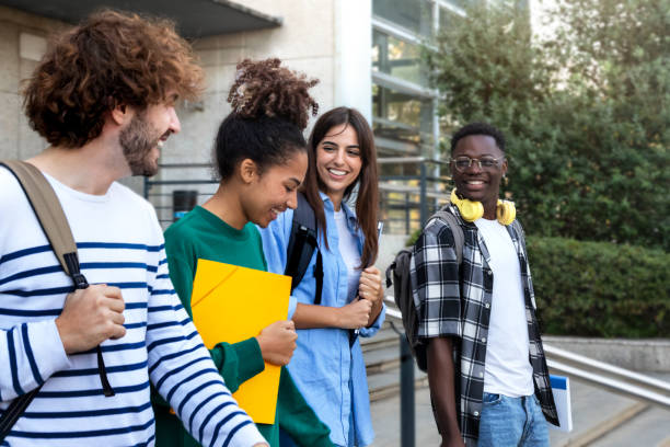 istock College friends walk to class together. Multiracial university students in campus talk and have fun outdoors. 1452682430