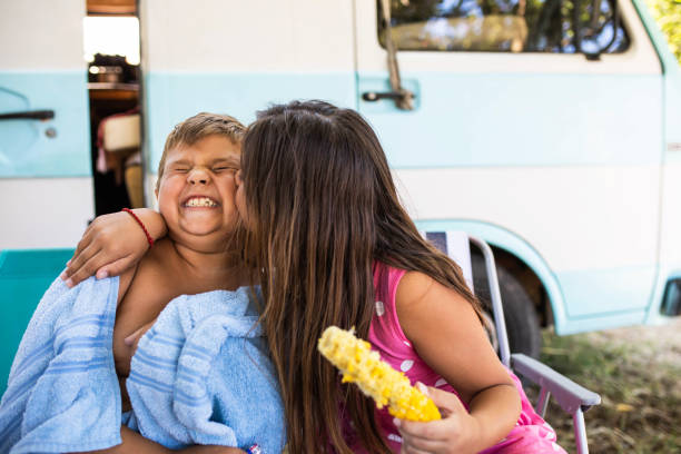 Cute siblings affectionate on a camping trip stock photo