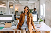 Portrait of young beautiful casually clothed woman in the modern office