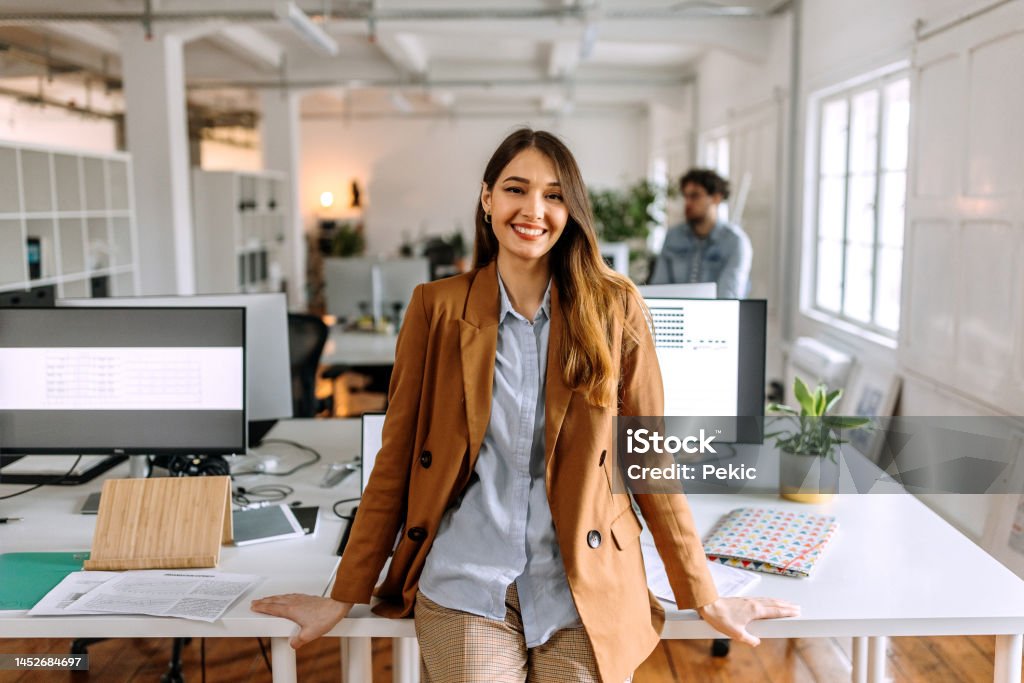Portrait of young beautiful casually clothed woman in the modern office Office Stock Photo