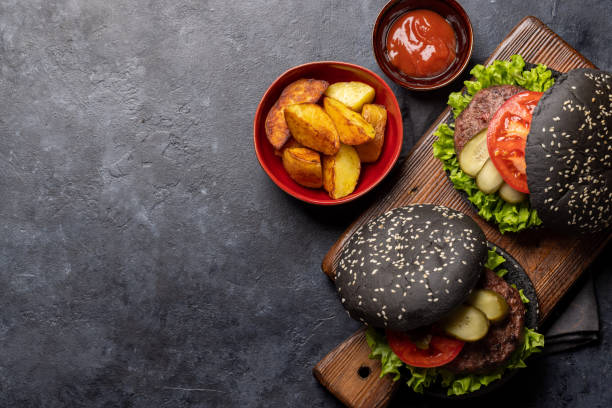 istock Homemade beef burgers with black buns 1452684759