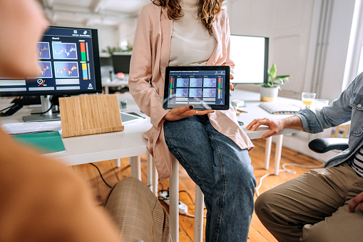 Colleagues analysing cryptocurrency market in a modern office