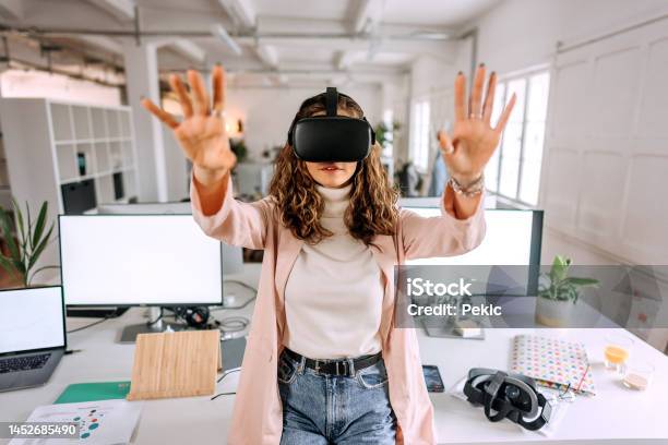 Young Beautiful Woman Using Vr Goggles In The Modern Office Stock Photo - Download Image Now