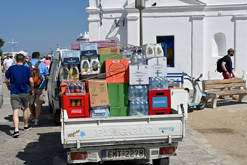 Mykonos, Greece - June 2022: Truck loaded with drinks for a bar viewed from the rear