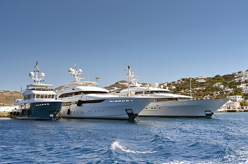 Mykonos, Greece - June 2022: Luxury yachts moored in the town's harbour