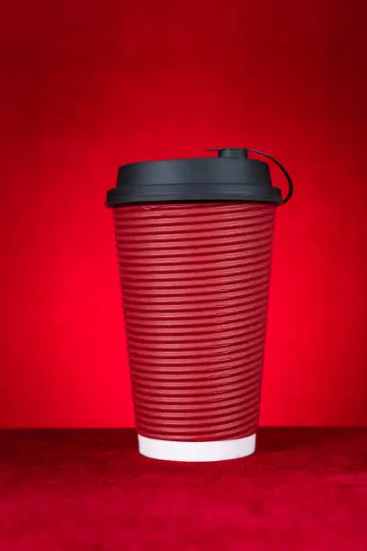 hotdrink paper cup on a red background vertical composition
