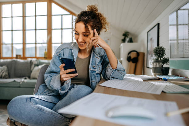 istock Young casually clothed teenage girl text messaging while taking a break from studying at her apartment 1452688417