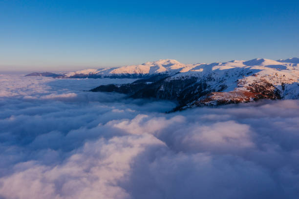 istock Caucasian mountains above the clouds at the sunset. Cloudscape, aerial view 1452690248