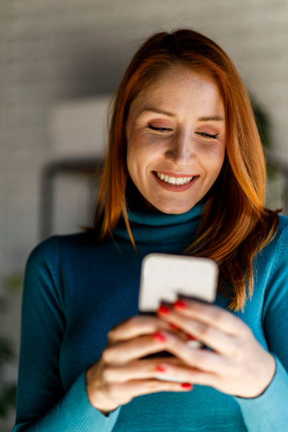 istock Young woman taking a work break and responding to a text message via smart phone 1452690530