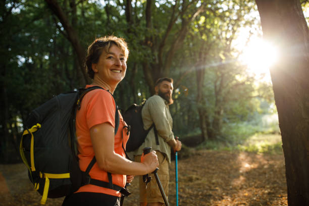 istock Woman and her son turning and looking over shoulder during a relaxing forest hike 1452691813