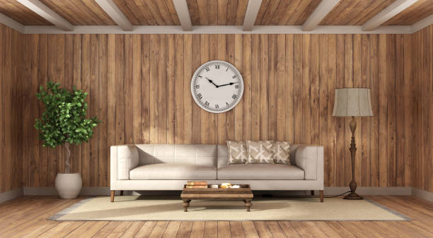 Wooden room with leather sofa and coffee table on carpet, floor lamp and houseplant - 3d render