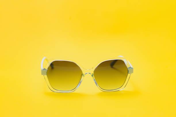 istock yellow sunglasses on yellow background 1452697525