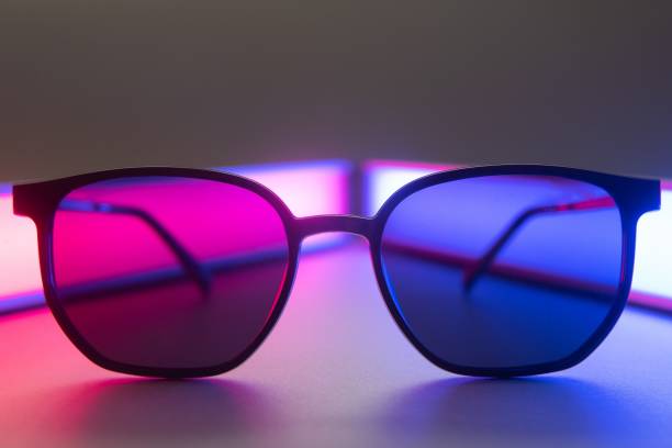 istock Stylish sunglasses shot using pink and blue abstract colored lighting with copy space. 1452697526