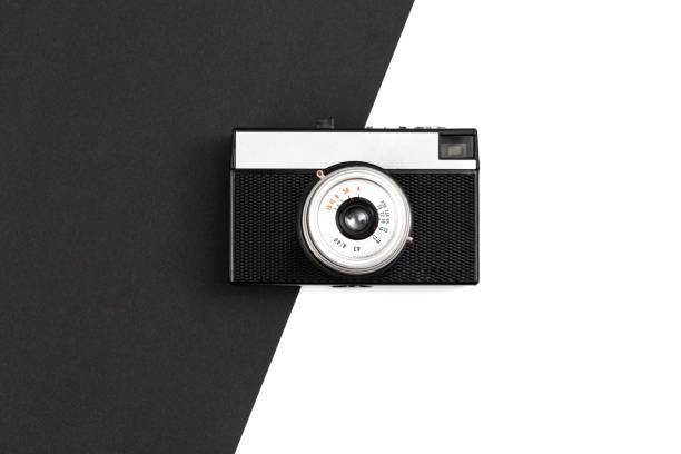 istock Old film camera on a black and white background, flat lay. 1452697634