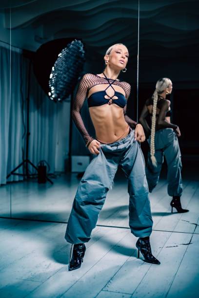 istock Vertical view of an attractive Stiletto dancer posing before the mirror in a studio 1452701120