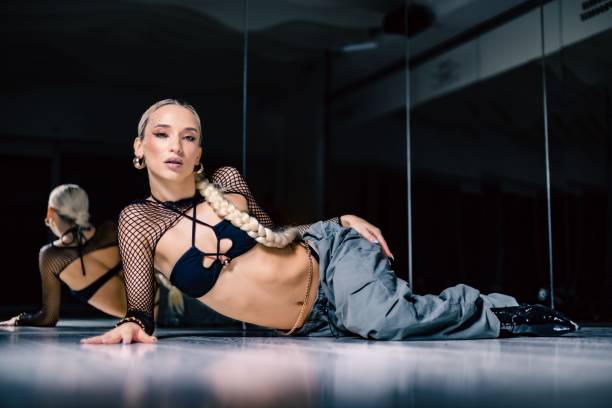 istock View of an attractive Stiletto dancer posing before the mirror in a studio 1452701127