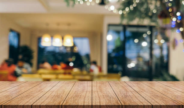 istock Empty wooden table top with lights bokeh on blur restaurant background. 1452701986