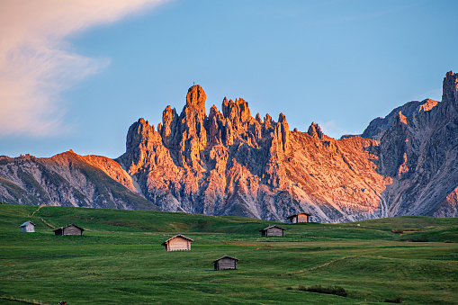 Seiser Alm (Italian: Alpe di Siusi is a Dolomite plateau and the largest high-altitude Alpine meadow at sunset with mountain glow
