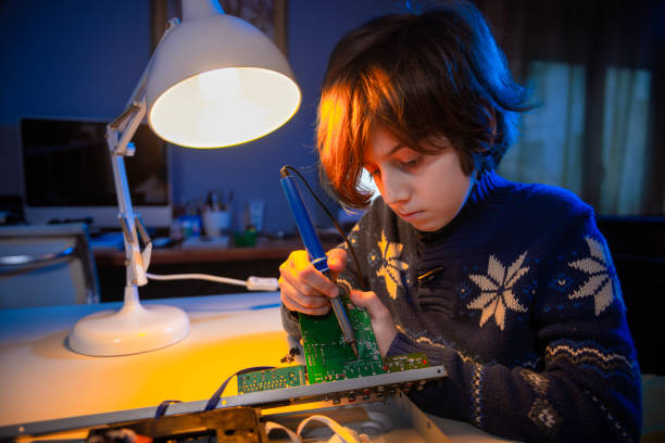 istock Little genius boy is fixing an electronic device. 1452703738