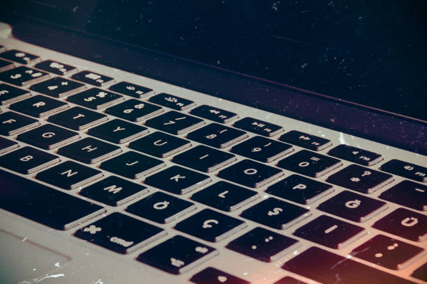 istock Open laptop with screen and keyboard view on the textured noir, vintage  background 1452708548