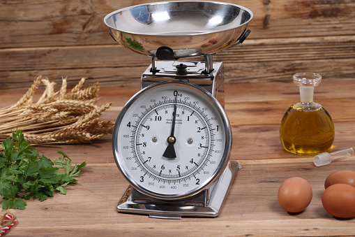 Antique scales with rustic background and vegetables