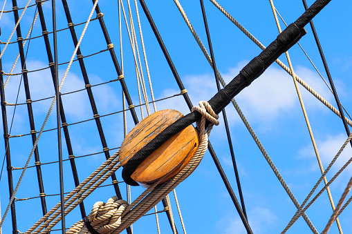 Parts of an old wooden deadeye on the shrouds of a sailing schooner, guys main mast. Ship rigging, shrouds and lanyards of an old wooden ship