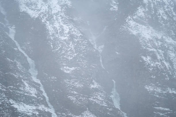 istock Clouds below the snow covered Himalayan mountains after the snowfall at Tinnan Valley in Lahaul Spiti district at Himachal Pradesh, India. Clouds under the snow covered mountains during the blizzard. 1452719446