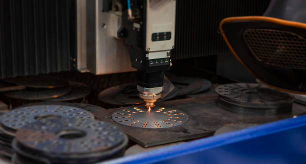 CNC laser cutting machine CNC laser cutting machine cutting holes on metal workpiece in factory. Industrial manufacture. gasket stock pictures, royalty-free photos & images