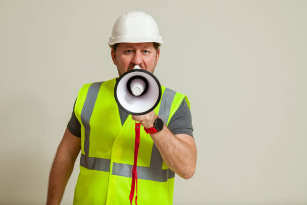 istock worker in a vest and white helmet 1452720836