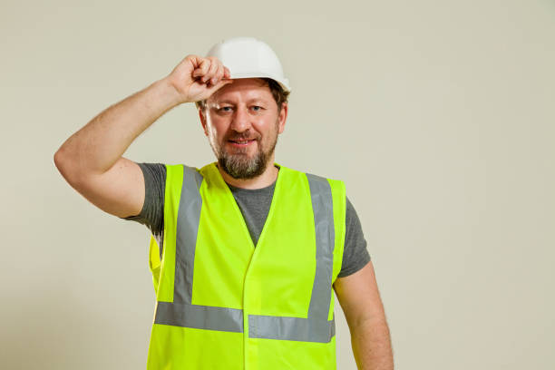 istock worker in a vest and white helmet 1452720841