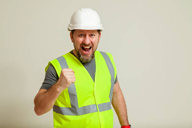istock worker in a vest and white helmet 1452720873