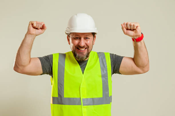 istock worker in a vest and white helmet 1452720876